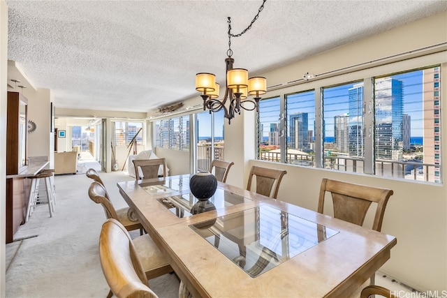 carpeted dining space with a textured ceiling and an inviting chandelier