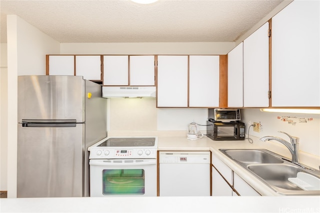 kitchen featuring white cabinets, sink, white appliances, and a textured ceiling