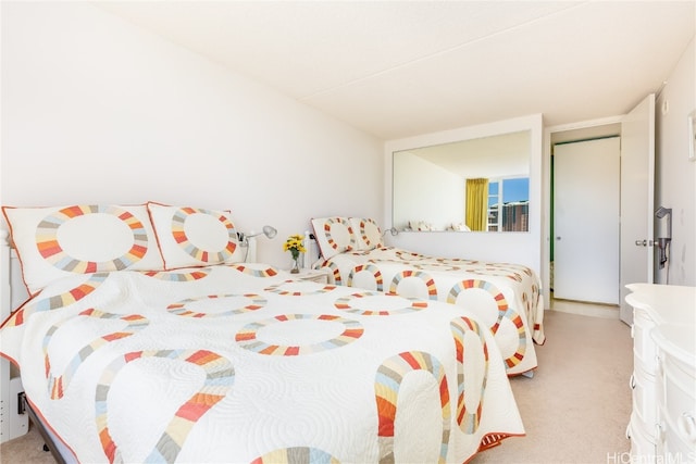 bedroom featuring light carpet and a closet