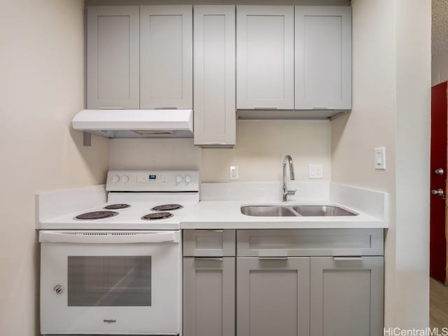 kitchen with sink, white range with electric stovetop, and gray cabinetry