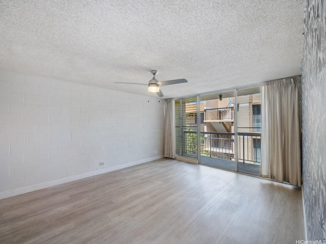 906 Lehua Ave Unit A306, Pearl City, HI 96782 - unfurnished room with wood finished floors, ceiling fan, floor to ceiling windows, a textured ceiling, and concrete block wall