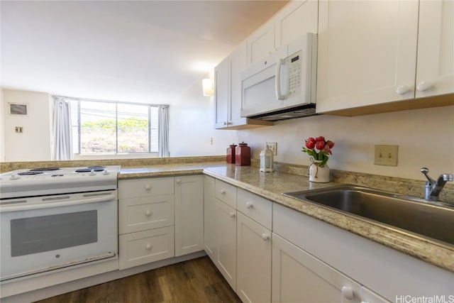 kitchen featuring white cabinetry, light stone countertops, dark hardwood / wood-style floors, sink, and white appliances