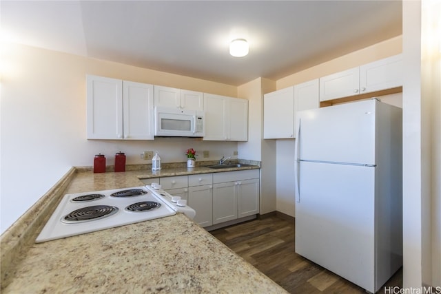 kitchen with white cabinetry, dark hardwood / wood-style floors, sink, and white appliances