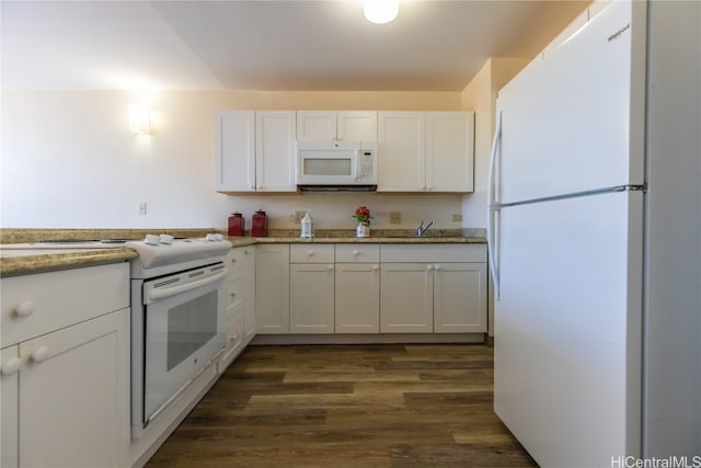 kitchen with white cabinetry, dark hardwood / wood-style floors, sink, and white appliances