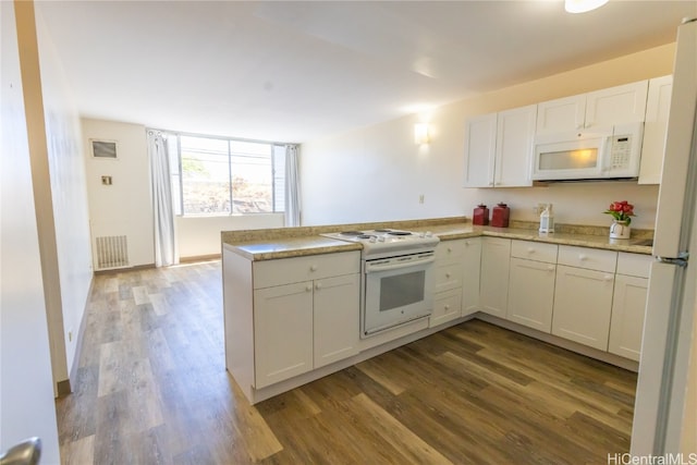 kitchen featuring white cabinetry, kitchen peninsula, wood-type flooring, and white appliances