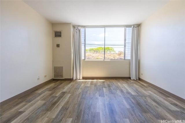 unfurnished room featuring dark hardwood / wood-style floors