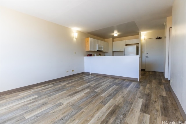 unfurnished living room featuring hardwood / wood-style floors