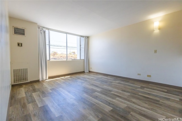 spare room featuring dark hardwood / wood-style floors