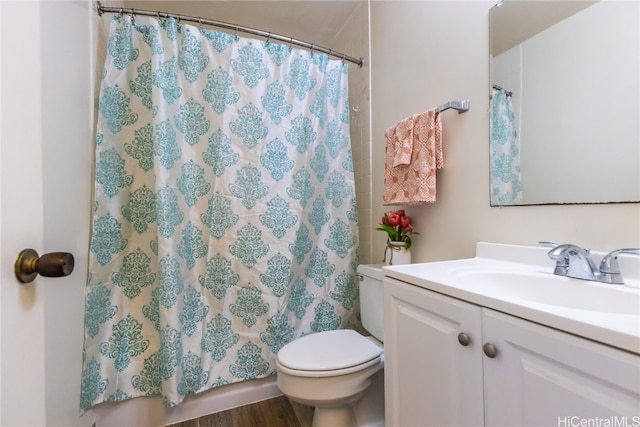 bathroom featuring vanity, hardwood / wood-style floors, and toilet