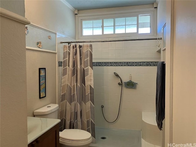 bathroom with a shower with curtain, vanity, toilet, and ornamental molding