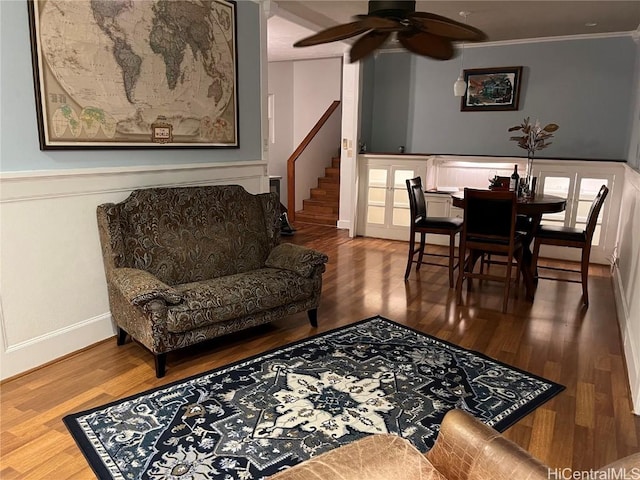 living room with hardwood / wood-style floors, ceiling fan, and ornamental molding