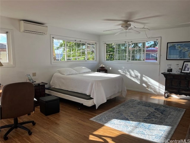 bedroom featuring a wall mounted air conditioner, ceiling fan, and dark wood-type flooring