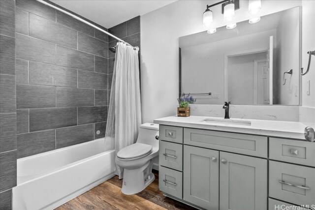 full bathroom with vanity, toilet, shower / tub combo with curtain, and hardwood / wood-style floors