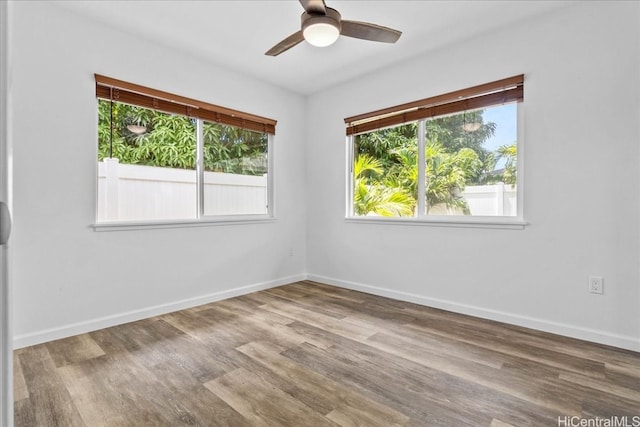 spare room with hardwood / wood-style floors and ceiling fan