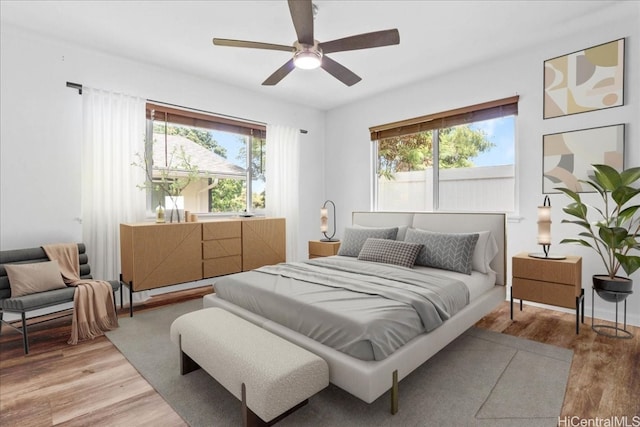 bedroom featuring light wood-type flooring and ceiling fan