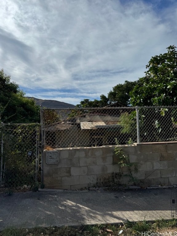 view of gate featuring a mountain view