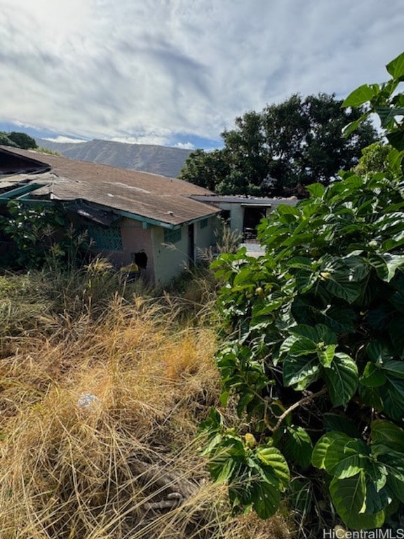 view of side of home with a mountain view