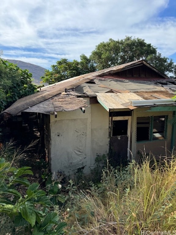 view of side of home featuring a mountain view