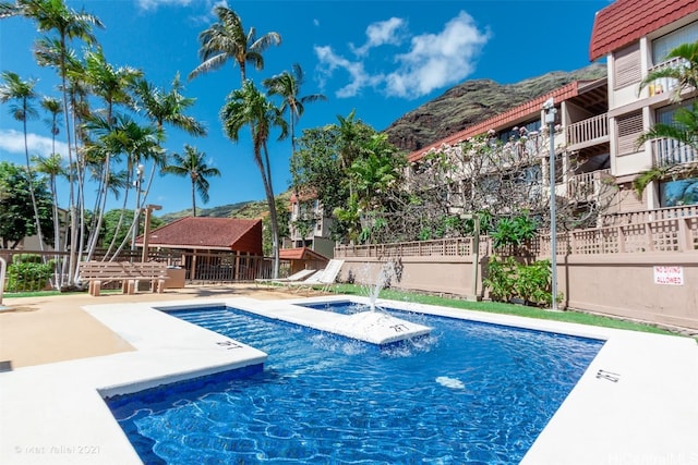 view of pool featuring a patio and a mountain view