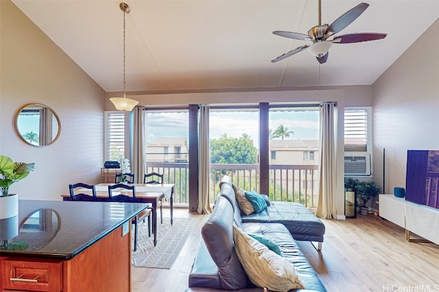 living room with light hardwood / wood-style flooring, ceiling fan, cooling unit, and vaulted ceiling