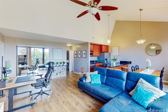 living room with light hardwood / wood-style flooring, high vaulted ceiling, and ceiling fan