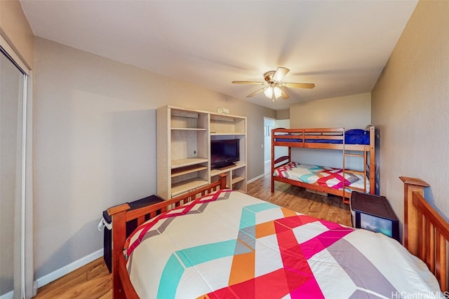 bedroom with light hardwood / wood-style flooring, a closet, and ceiling fan