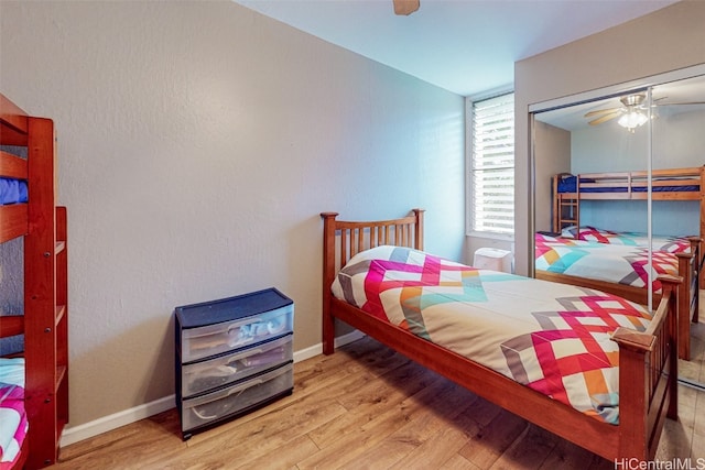 bedroom featuring a closet, light hardwood / wood-style floors, and ceiling fan