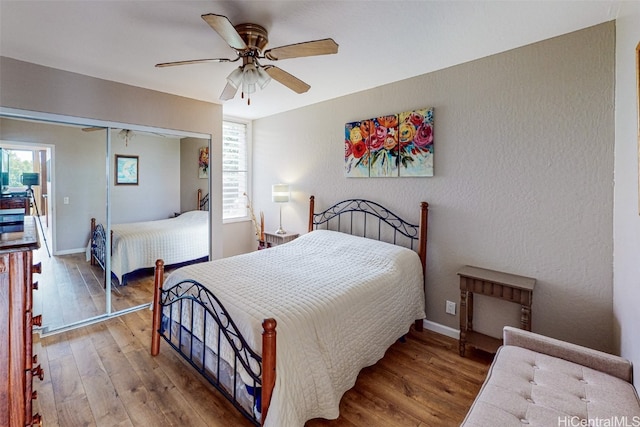 bedroom with a closet, ceiling fan, and hardwood / wood-style floors