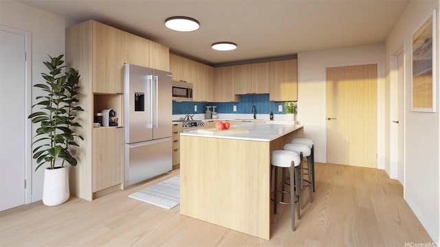 2599 Kapiolani Blvd Unit 312, Honolulu, HI 96826 - kitchen with stainless steel appliances, a sink, light wood-style floors, modern cabinets, and light countertops