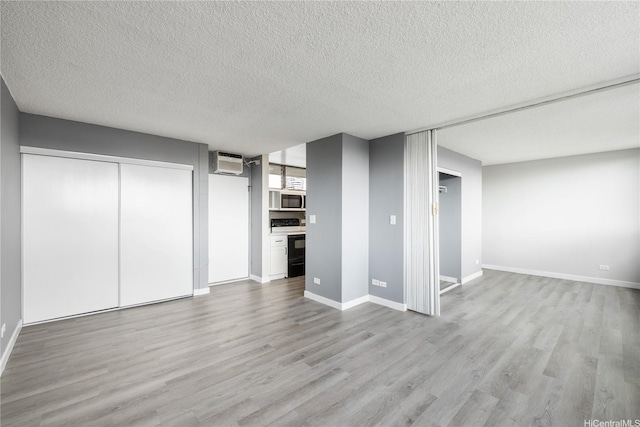 1040 Kinau St Unit 803, Honolulu, HI 96814 - below grade area featuring wood finished floors, a textured ceiling, baseboards, and a wall unit AC