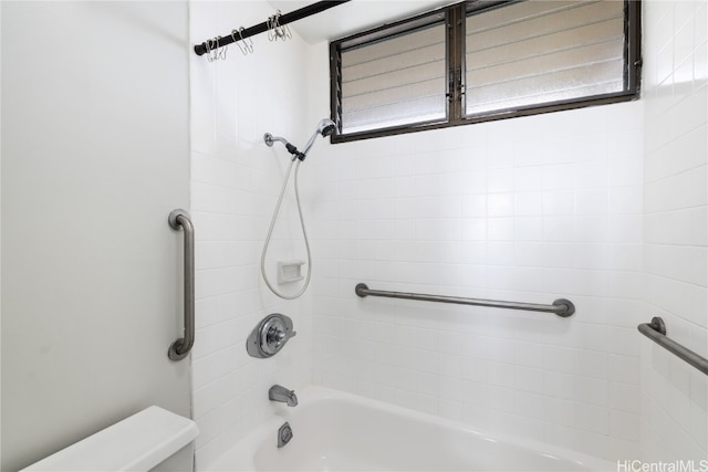 full bathroom with washtub / shower combination and toilet