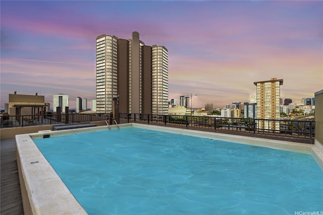 pool at dusk with a view of city