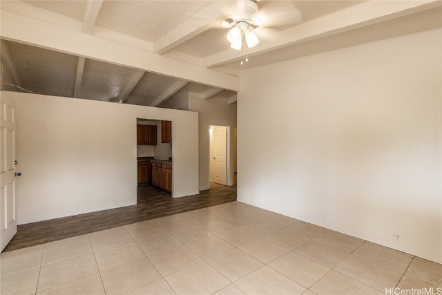 spare room with vaulted ceiling with beams, light hardwood / wood-style floors, and ceiling fan