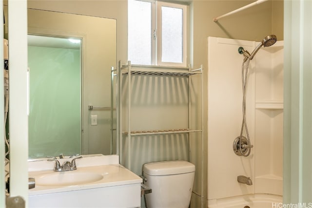 full bathroom featuring bathtub / shower combination, vanity, and toilet