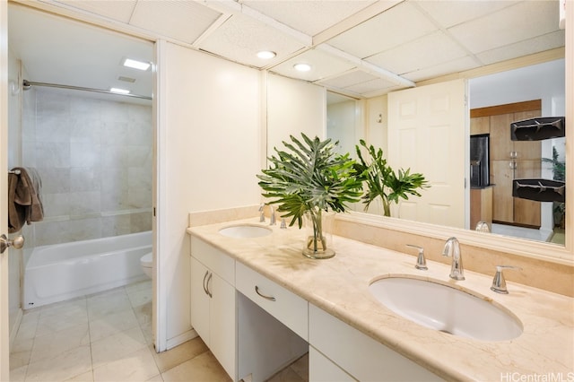 full bathroom with vanity, toilet, tile patterned floors, and tiled shower / bath combo