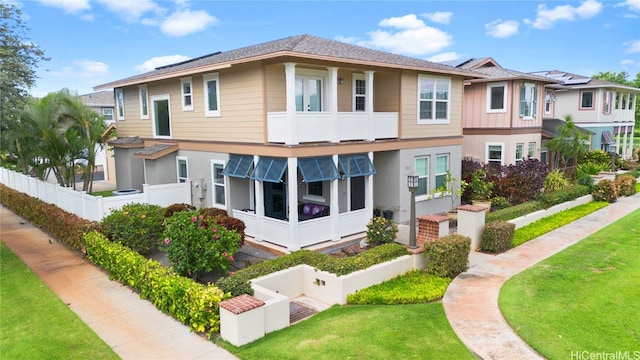 exterior space featuring a balcony and a lawn