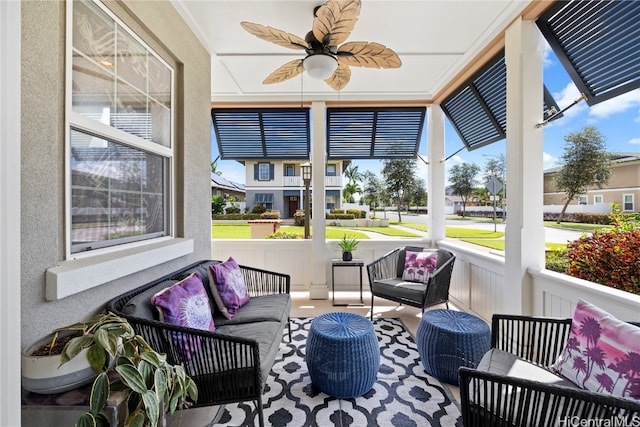 sunroom featuring ceiling fan