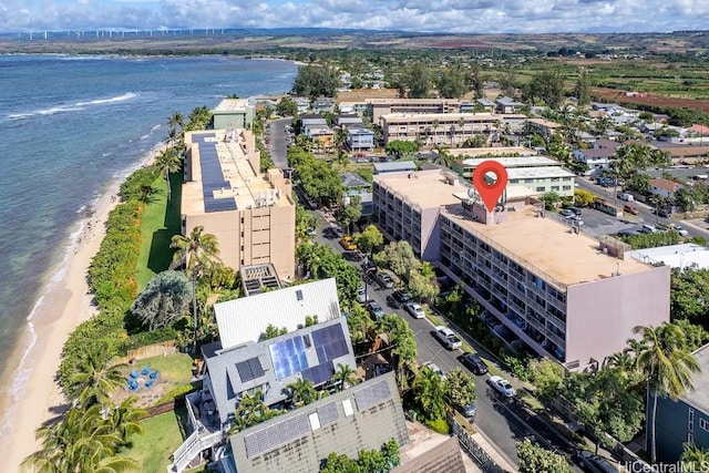 drone / aerial view with a water view and a beach view