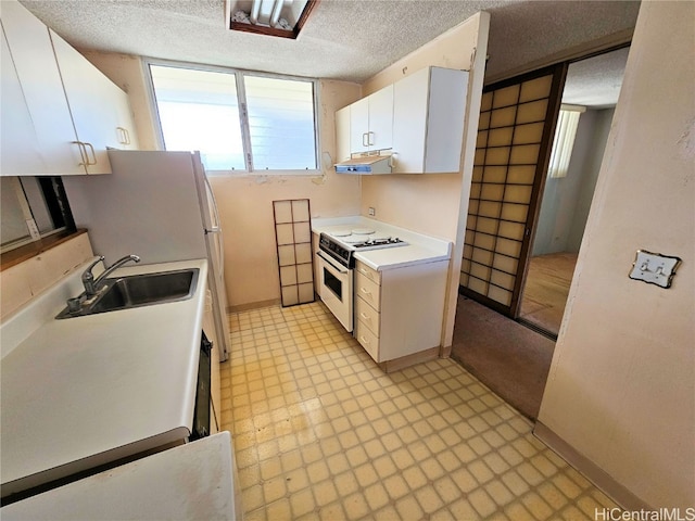 kitchen with extractor fan, white range oven, sink, white cabinetry, and a textured ceiling