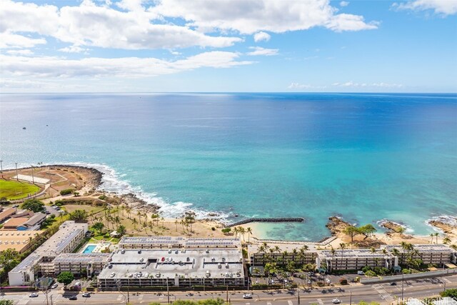 birds eye view of property with a water view and a beach view