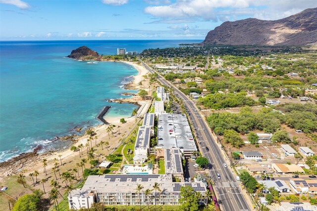 drone / aerial view featuring a water and mountain view and a view of the beach