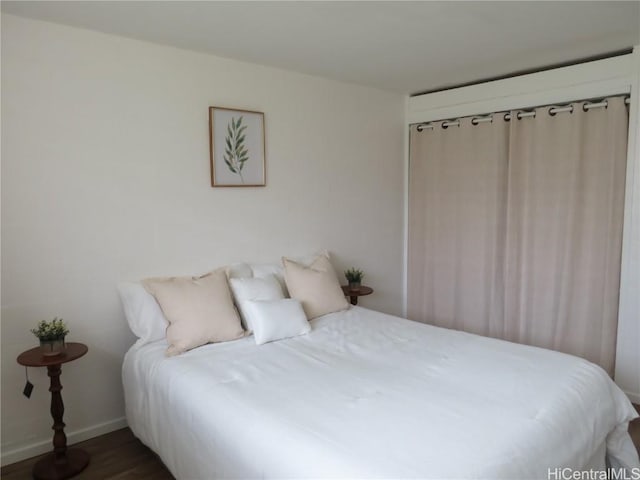 bedroom with dark hardwood / wood-style floors