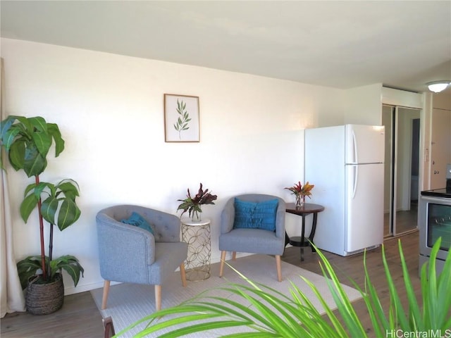 living area with hardwood / wood-style flooring