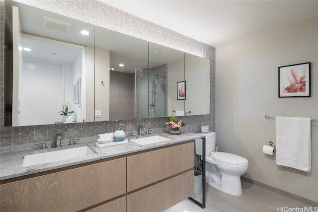 bathroom featuring backsplash, a shower with shower door, toilet, vanity, and tile patterned flooring