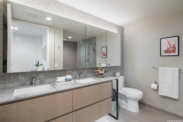 full bath with toilet, baseboards, tasteful backsplash, a shower stall, and double vanity