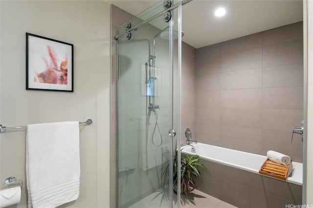 bathroom with a shower stall and a bath