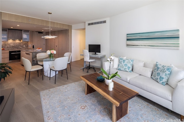 living room featuring light hardwood / wood-style flooring and sink