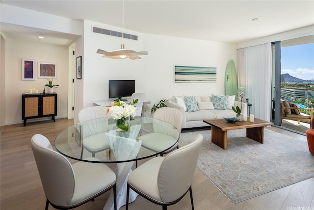 dining space with wood finished floors