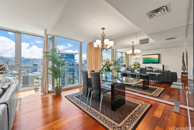 dining area featuring a chandelier, hardwood / wood-style floors, and a wall of windows