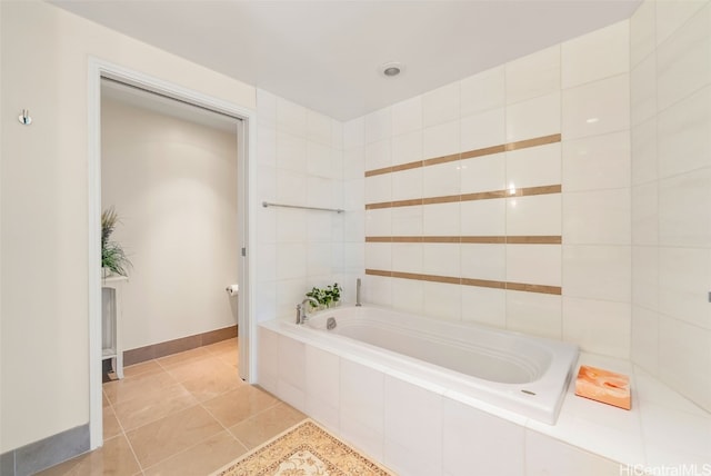 bathroom featuring tile patterned floors and tiled tub